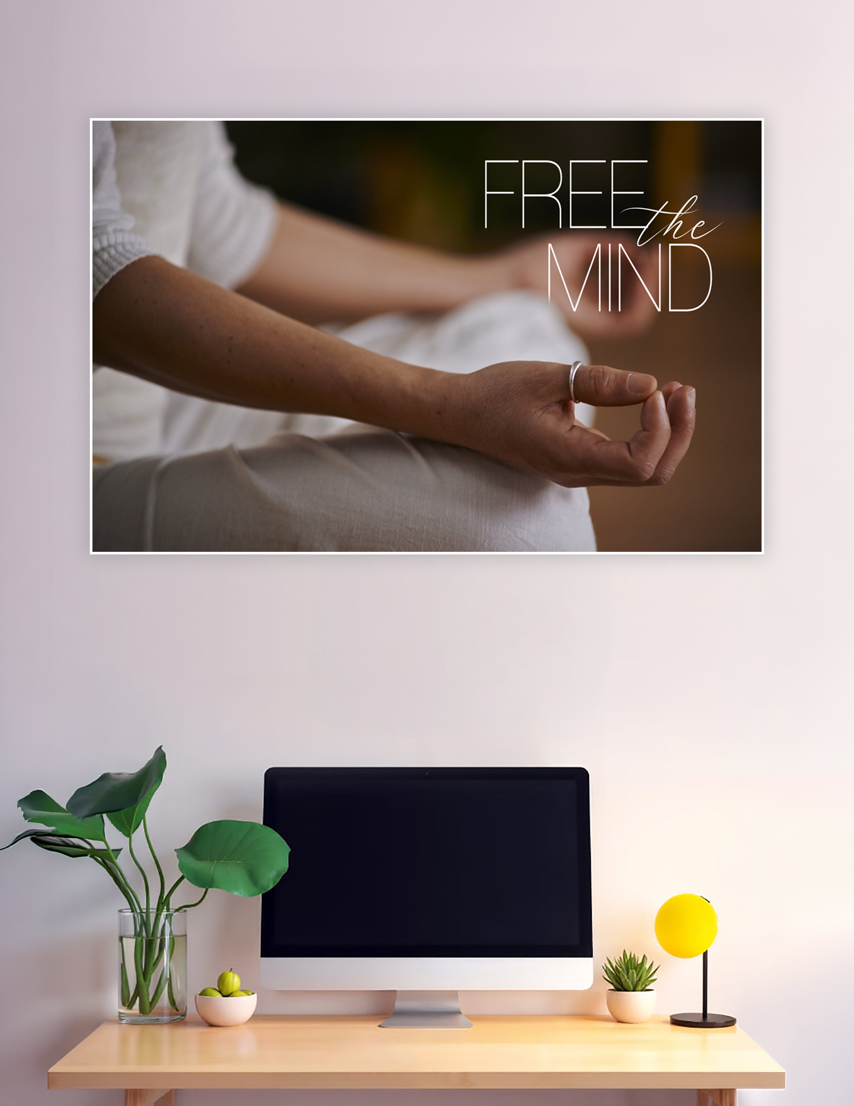 Close-up of hands in a meditation mudra pose with the text 'Free the Mind' overlaid in elegant typography on a warm bokeh background