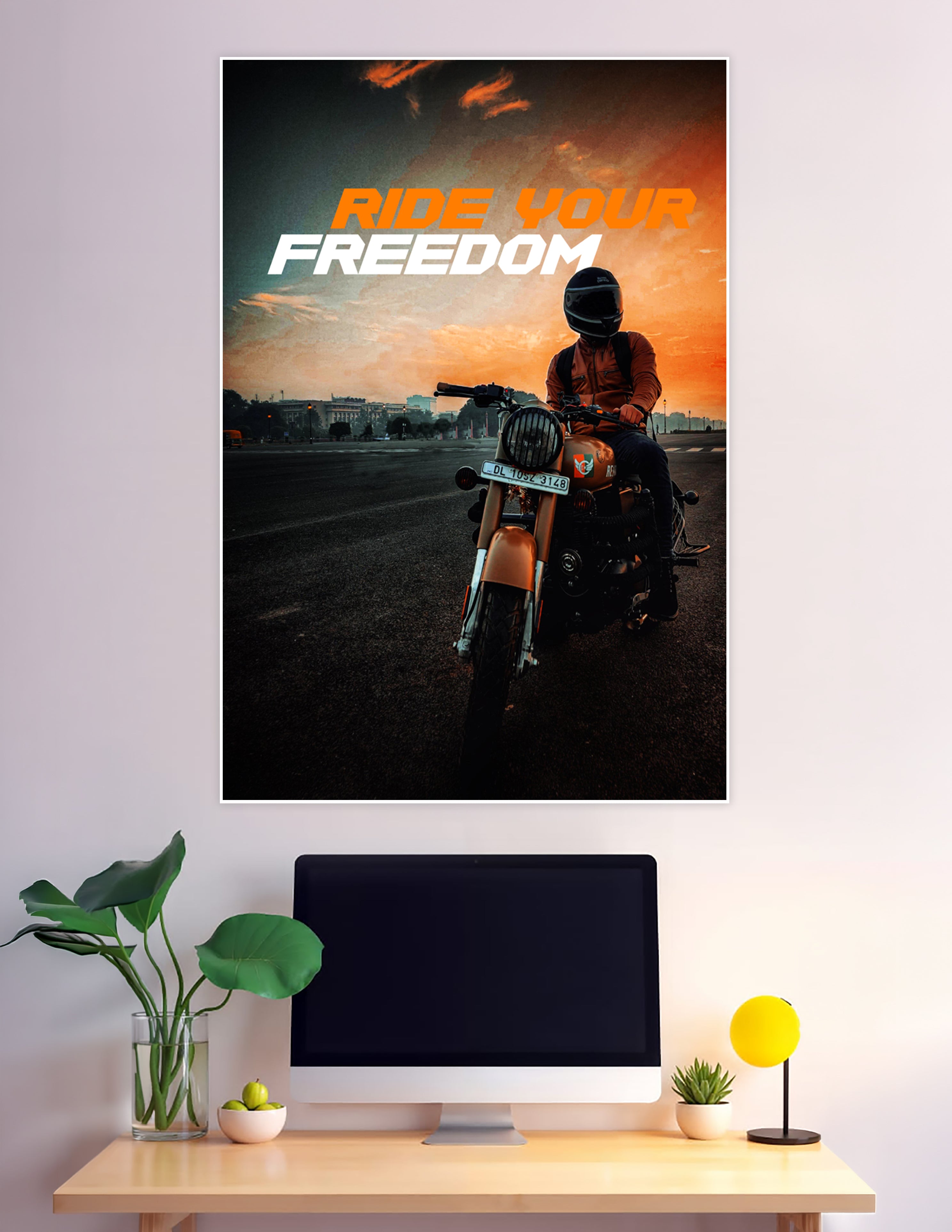 Helmeted motorcycle rider on a Royal Enfield against a dramatic orange sunset sky with bold 'Ride Your Freedom' typography poster