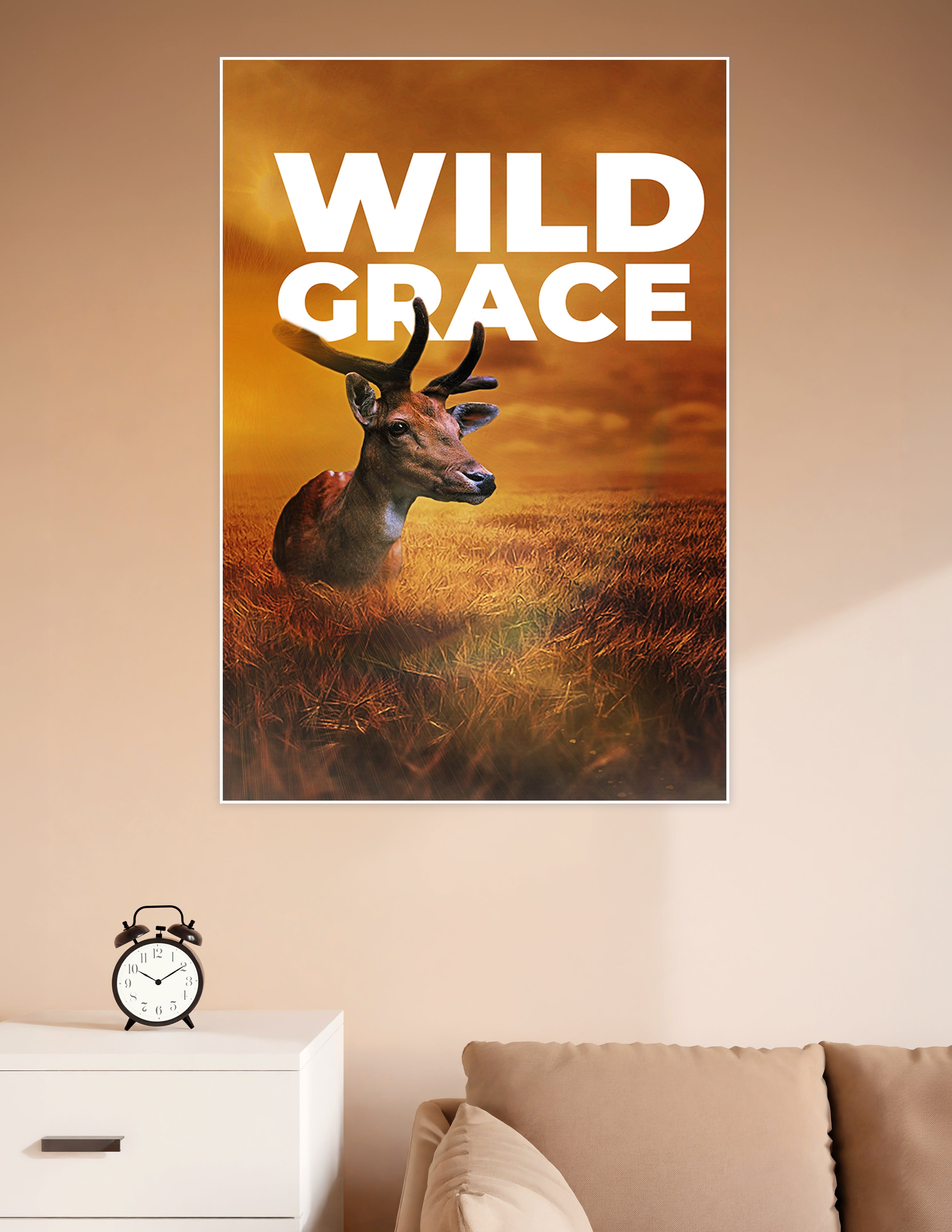Wild Grace poster featuring a majestic deer resting in a golden wheat field under a dramatic amber sunset sky