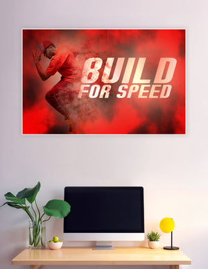 Athlete in red outfit sprinting through a dramatic red powder cloud with bold 'Build For Speed' typography on a motivational sports poster