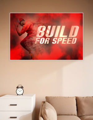 Athlete in red outfit sprinting through a dramatic red powder cloud with bold 'Build For Speed' typography on a motivational sports poster