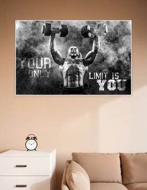 Black and white motivational gym poster of a muscular bald man lifting dumbbells overhead through smoke with the text Your Only Limit Is You