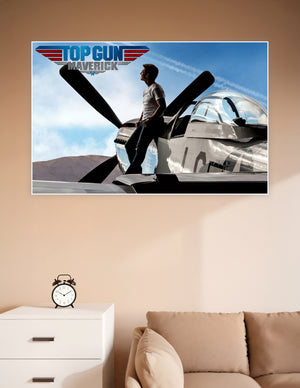 Top Gun Maverick movie poster showing a man standing on a vintage P-51 Mustang propeller aircraft under a blue sky with the Top Gun Maverick logo