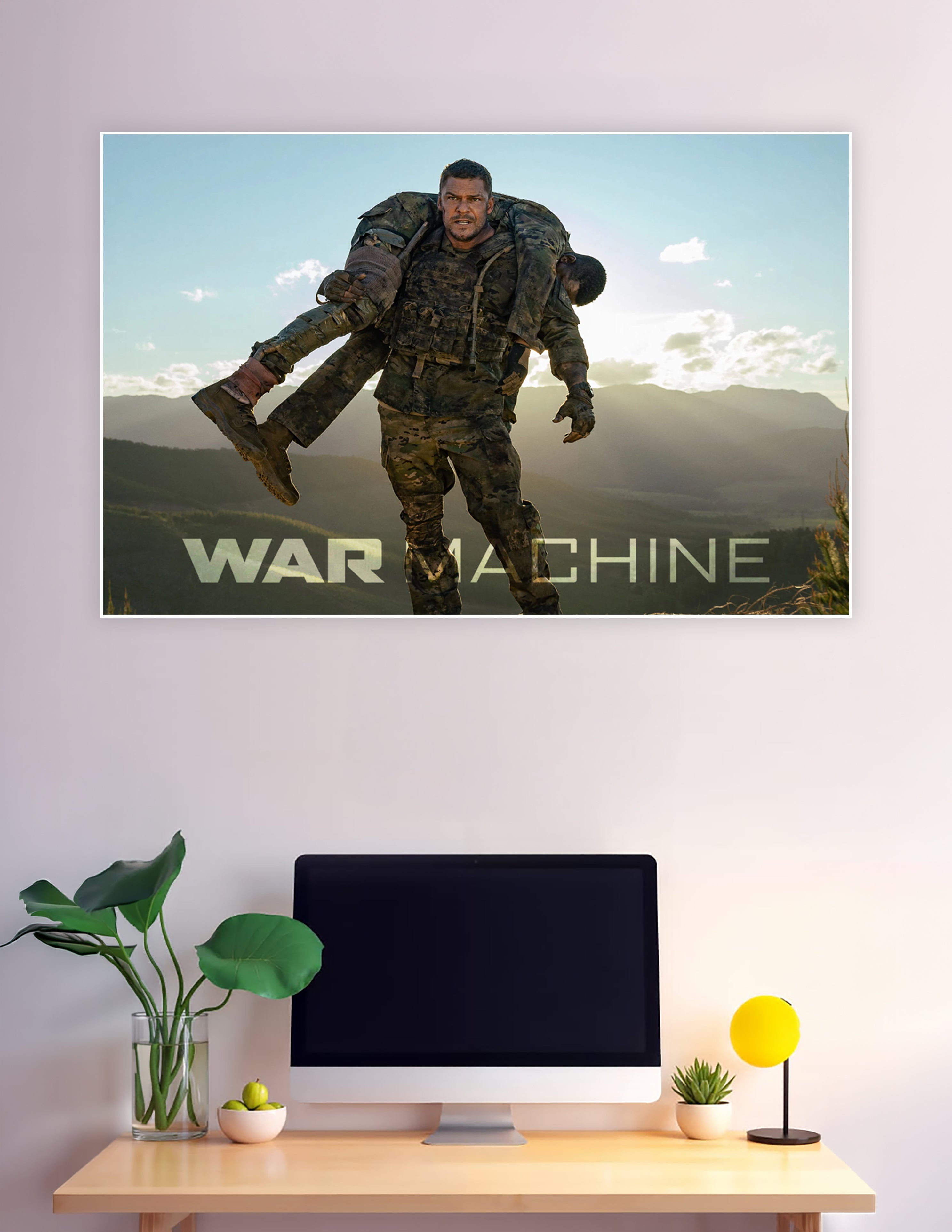 War Machine movie poster showing a soldier in camouflage carrying an injured comrade over his shoulders against a dramatic mountain sunset backdrop