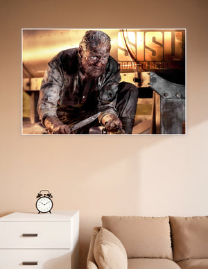 Sisu Road to Revenge movie poster featuring a battle-scarred warrior crouching with a blade, covered in grime against a golden cinematic background