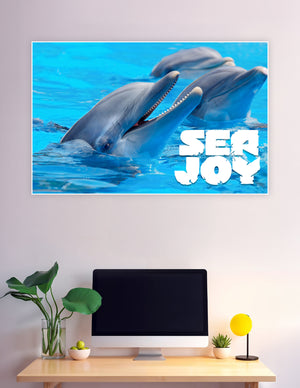 Two playful bottlenose dolphins emerging from bright blue water with Sea Joy text overlay, premium matte wall poster print