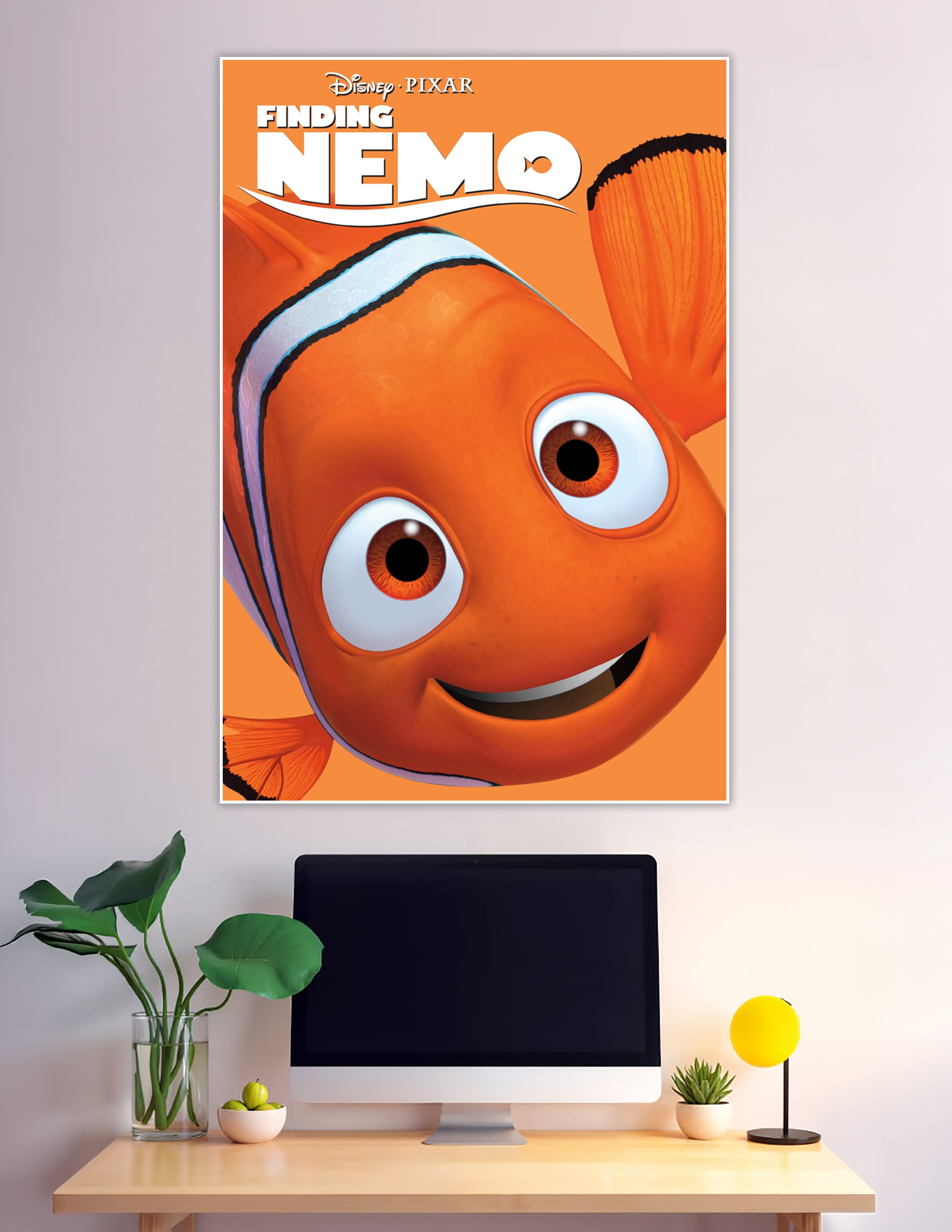 Disney Pixar Finding Nemo official movie poster featuring a close-up of Nemo the clownfish smiling on a bright orange background