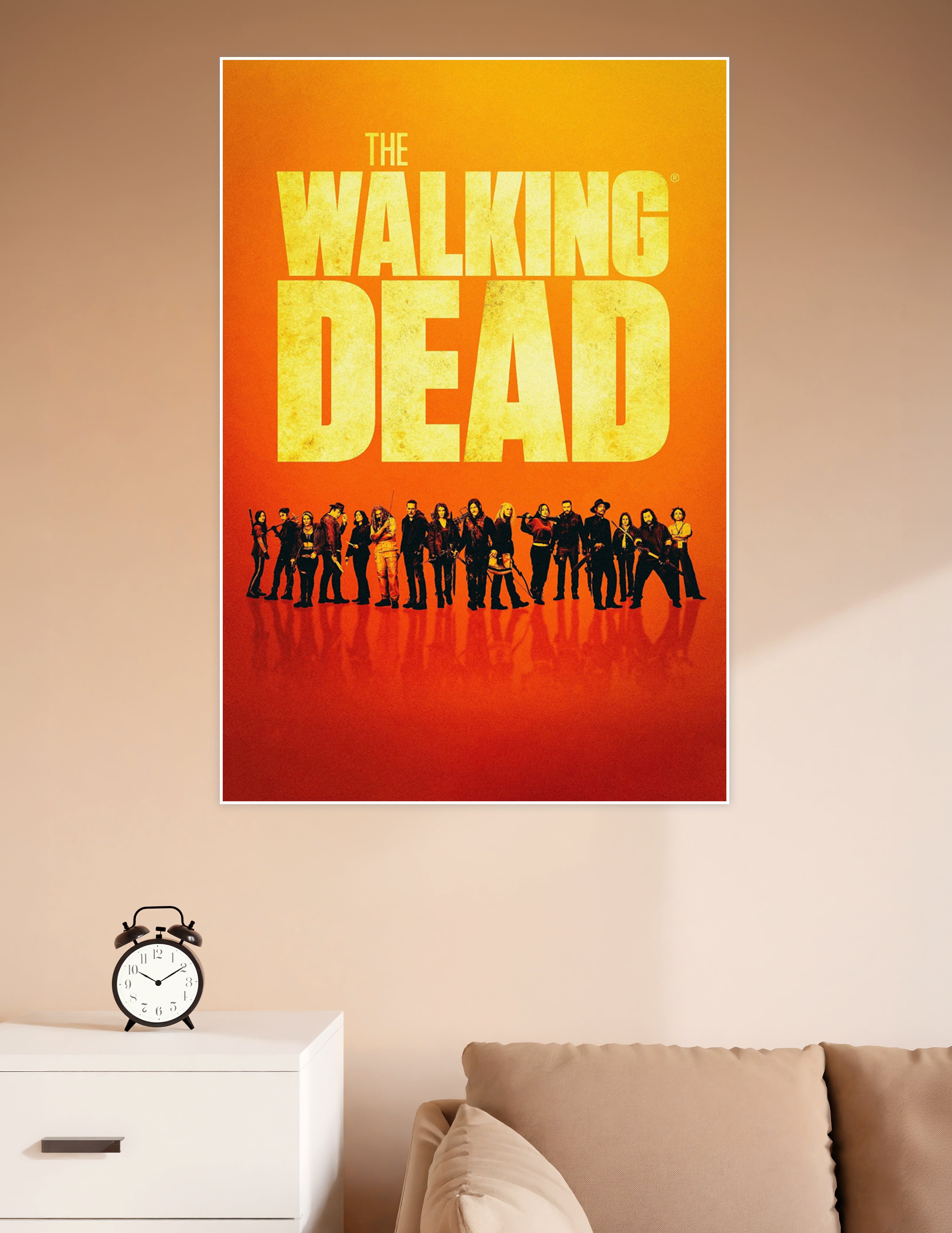The Walking Dead official cast poster with ensemble lineup silhouetted against a fiery orange gradient background and bold yellow title typography