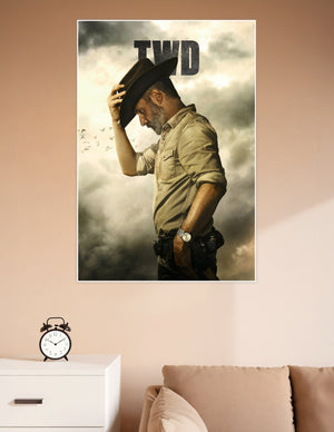 TWD promotional poster of Rick Grimes in side profile tipping his cowboy hat against a dramatic stormy sky with birds flying in the background
