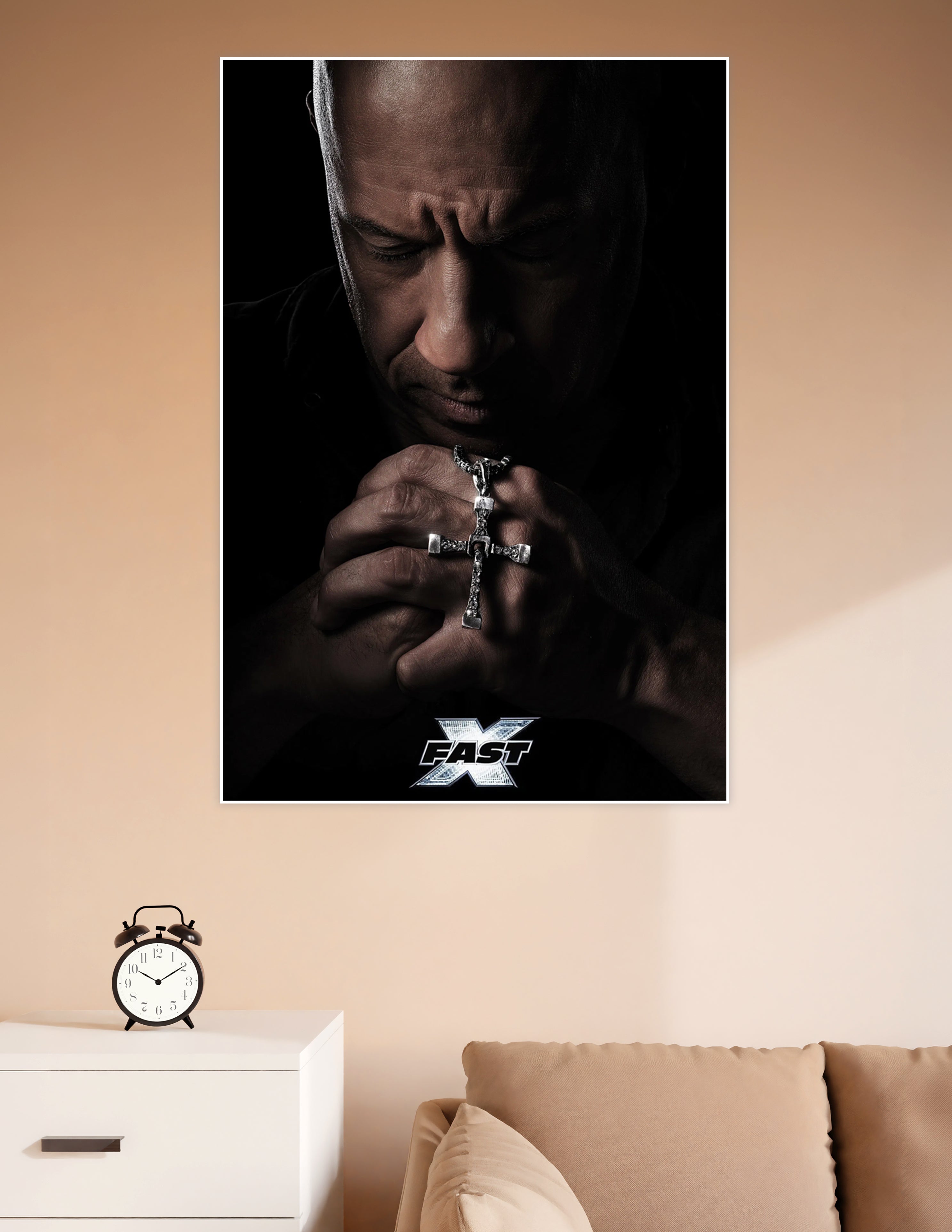 Fast X movie poster showing Dominic Toretto praying with hands clasped around a silver cross necklace against a dark dramatic background