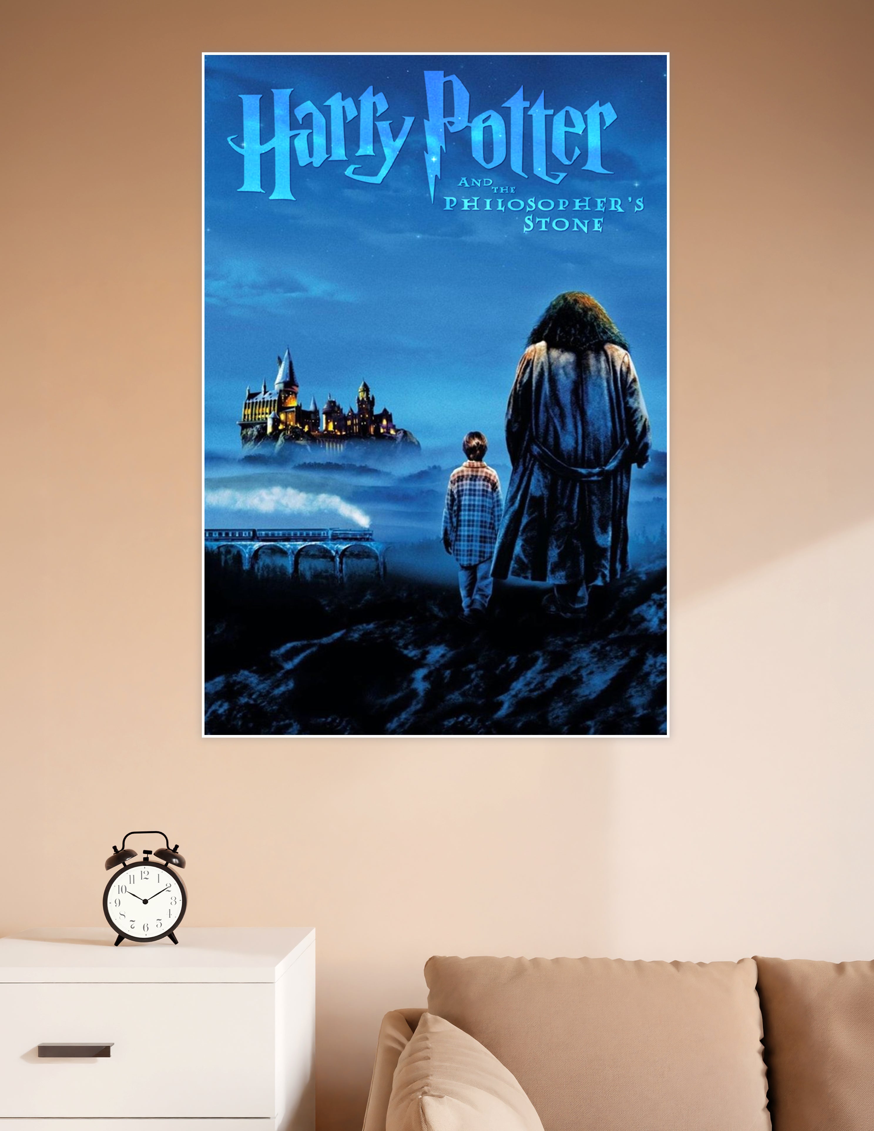 Harry Potter and the Philosopher's Stone movie poster showing two silhouetted figures — a child and a giant — gazing at the glowing Hogwarts castle through misty blue night skies with the Hogwarts Express crossing a viaduct below