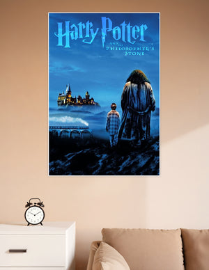 Harry Potter and the Philosopher's Stone movie poster showing two silhouetted figures — a child and a giant — gazing at the glowing Hogwarts castle through misty blue night skies with the Hogwarts Express crossing a viaduct below