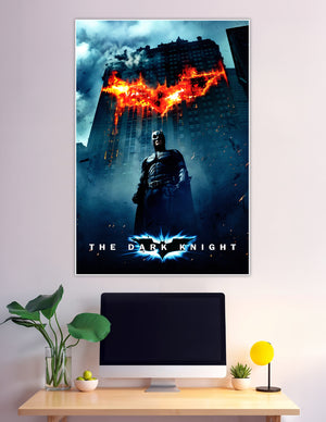 Batman standing before flaming bat symbol on Gotham building