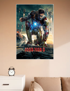 Iron Man 3 movie poster showing Tony Stark in damaged red and gold Mark XLII armor kneeling on a surface with arc reactor glowing and multiple Iron Man suits flying in the background