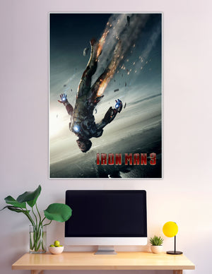 Iron Man 3 movie poster showing Tony Stark falling in a damaged burning Iron Man suit with debris and fire against a dark sky