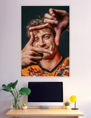 Confident athlete framing face with fingers orange jersey
