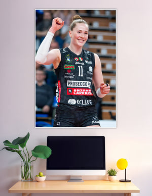 Female volleyball player number 11 celebrating victory fist raised