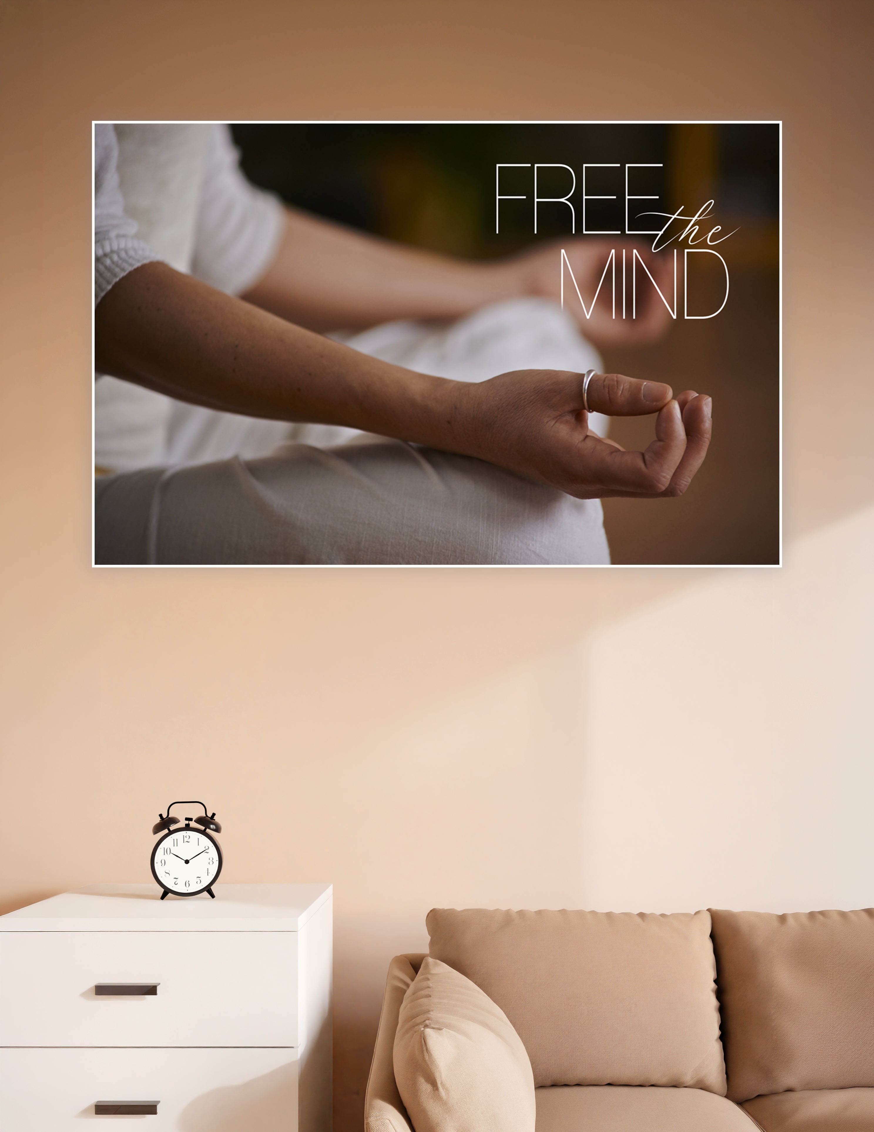 Close-up of hands in a meditation mudra pose with the text 'Free the Mind' overlaid in elegant typography on a warm bokeh background