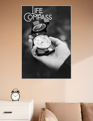 Black and white poster showing a hand holding a military compass with bold Life Compass typography overlay