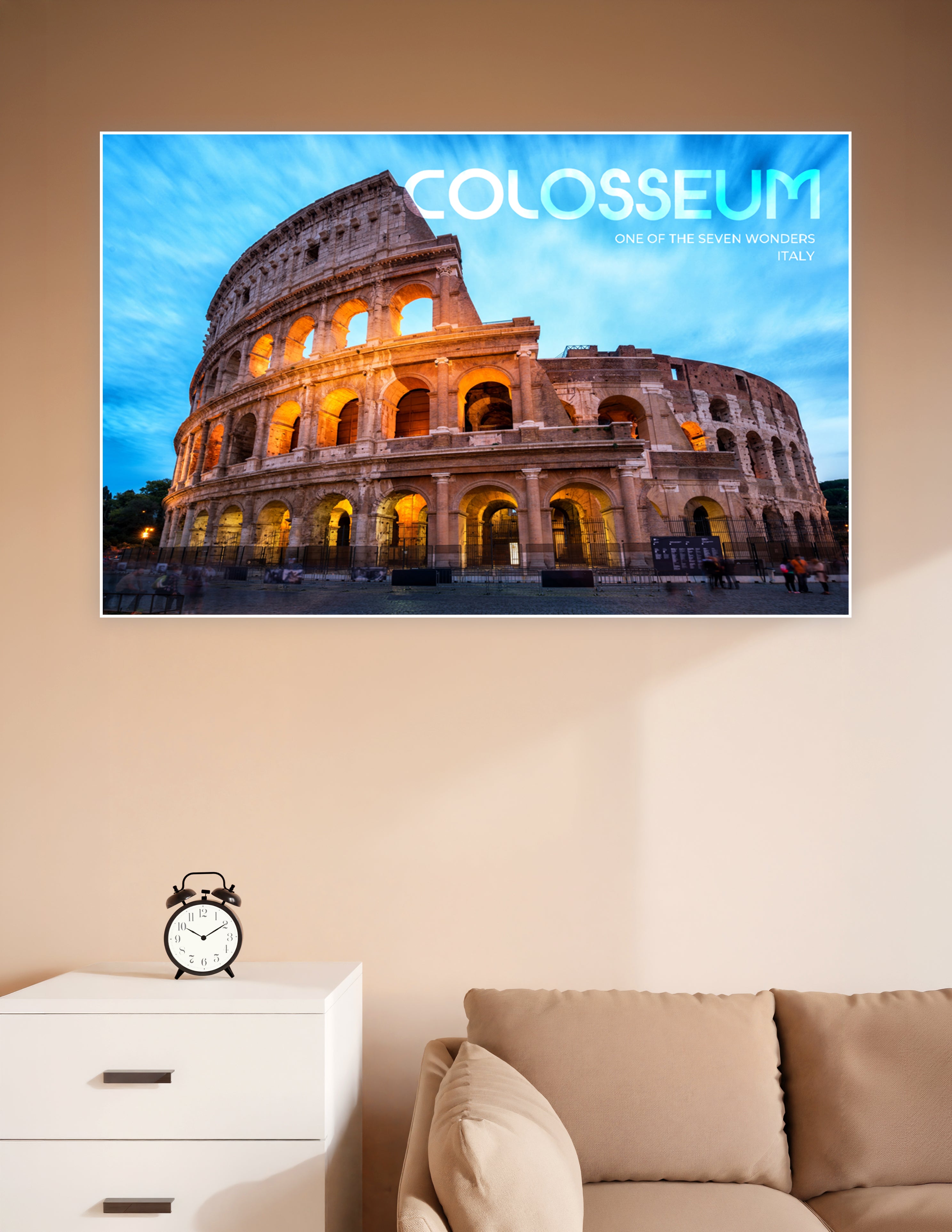 Dramatic twilight poster of the Colosseum in Rome, Italy, illuminated in golden light against a vivid blue sky, labeled as one of the Seven Wonders