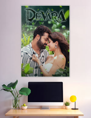 Devara movie poster featuring the romantic lead pair in an intimate moment surrounded by lush green foliage with the Devara title logo