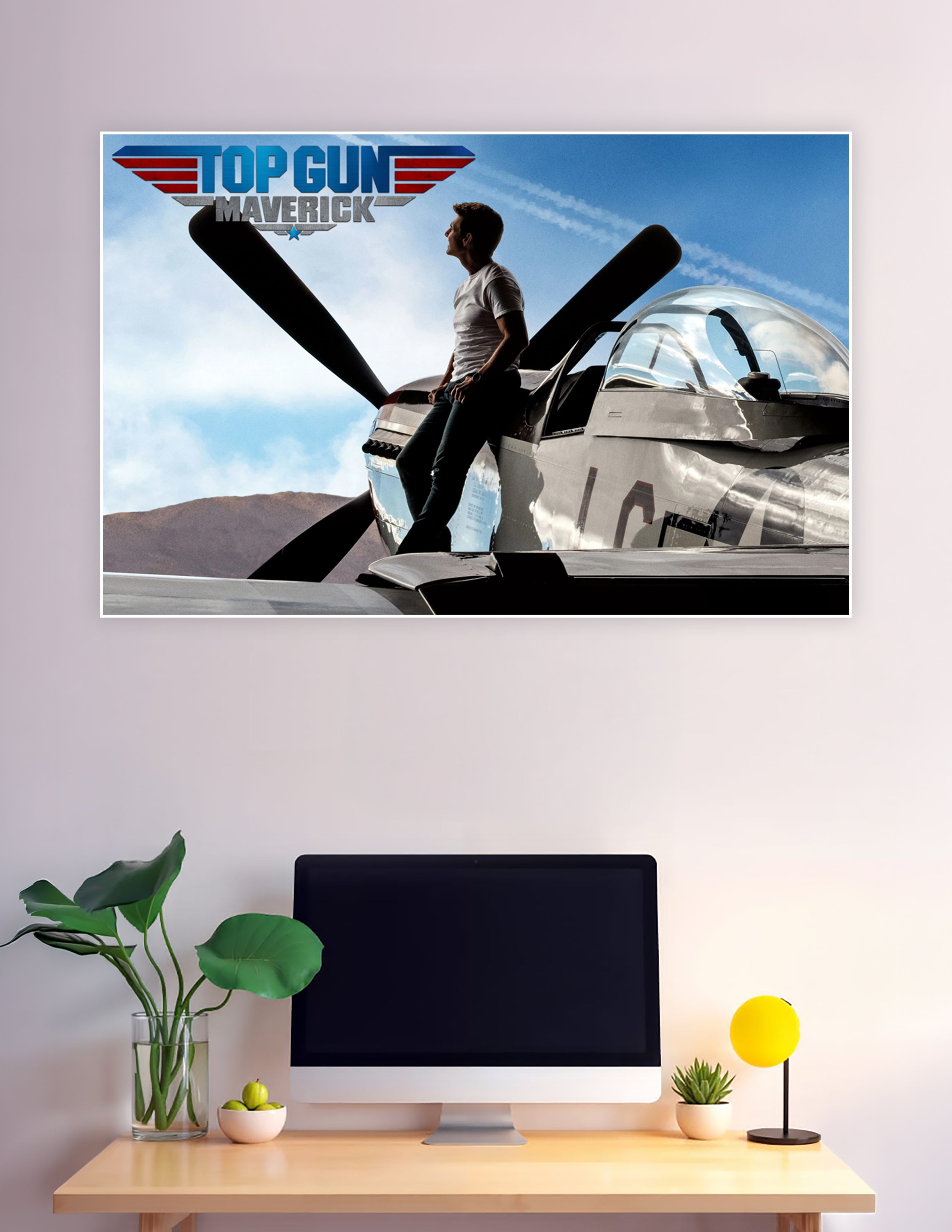 Top Gun Maverick movie poster showing a man standing on a vintage P-51 Mustang propeller aircraft under a blue sky with the Top Gun Maverick logo