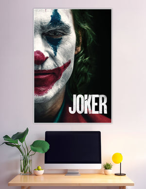 Close-up Joker movie poster showing white face paint, red clown smile, blue tear streak, and green hair on a dark background with bold JOKER title text