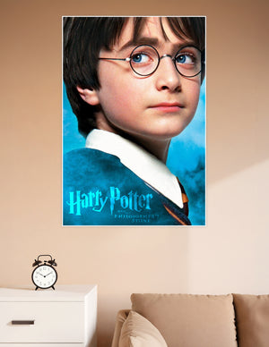Harry Potter and the Philosopher's Stone movie poster featuring a close-up of young Harry Potter wearing round glasses and Hogwarts robes against a teal blue background