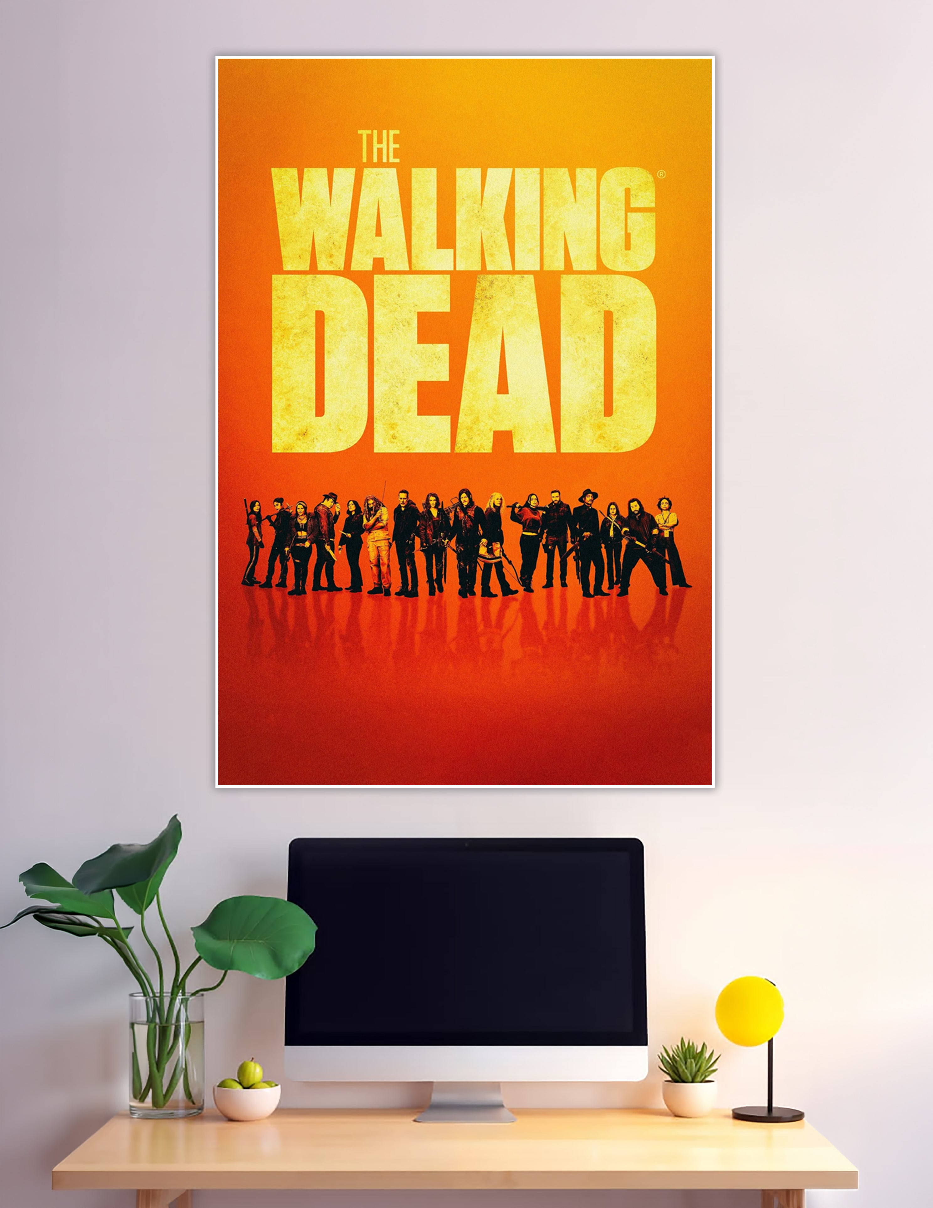The Walking Dead official cast poster with ensemble lineup silhouetted against a fiery orange gradient background and bold yellow title typography
