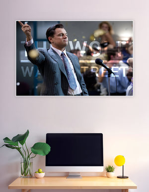 Wolf of Wall Street movie poster featuring a man in a pinstripe suit pointing upward at a microphone with bold title text overlay
