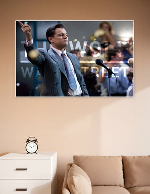 Wolf of Wall Street movie poster featuring a man in a pinstripe suit pointing upward at a microphone with bold title text overlay