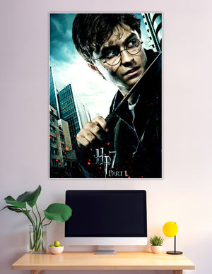 Harry Potter gripping his wand in a dramatic battle-ready pose on the HP7 Deathly Hallows Part 1 movie poster with stormy cityscape background