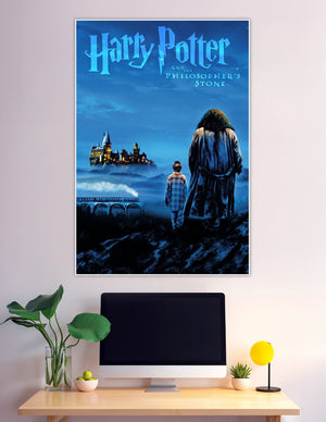 Harry Potter and the Philosopher's Stone movie poster showing two silhouetted figures — a child and a giant — gazing at the glowing Hogwarts castle through misty blue night skies with the Hogwarts Express crossing a viaduct below