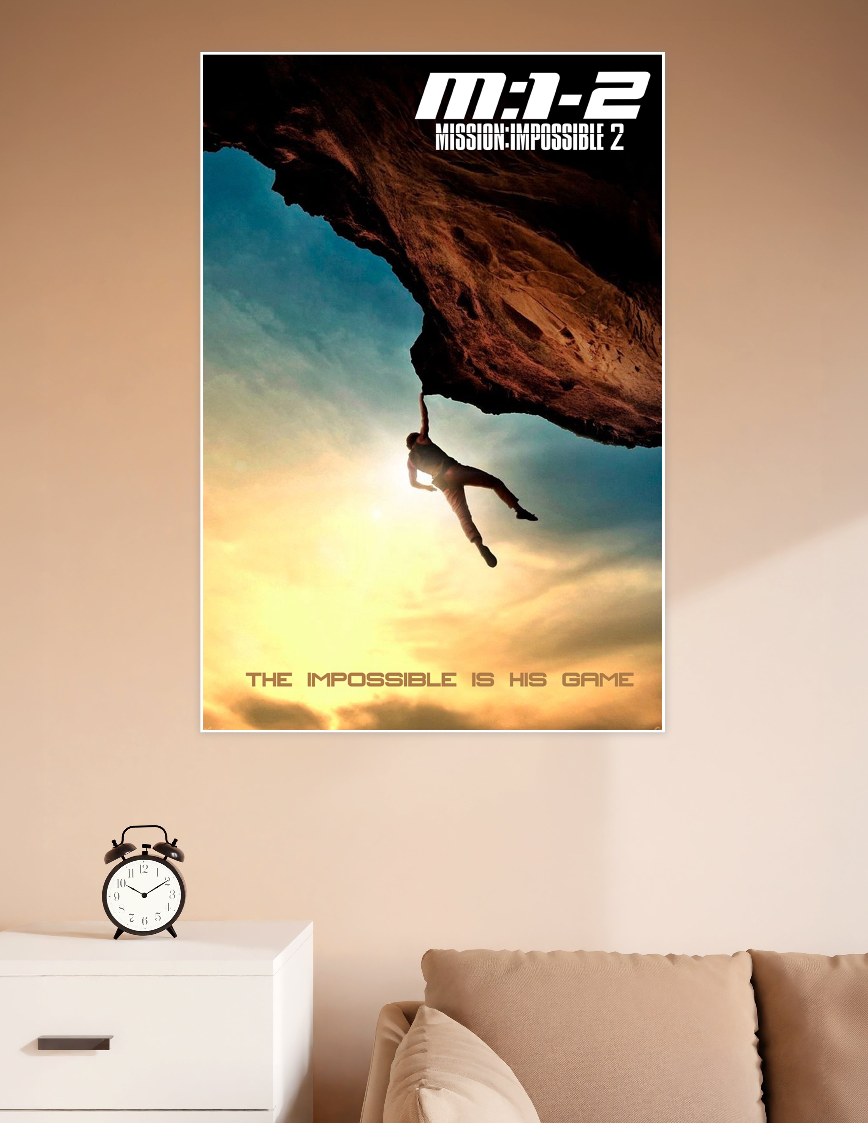 Mission Impossible 2 movie poster showing a silhouetted figure hanging from a rock overhang against a dramatic golden sunset sky with the tagline The Impossible Is His Game