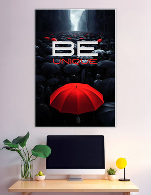 Motivational poster showing a bold red umbrella standing out among a crowd of dark umbrellas on a rainy city street with 'Be Unique' text overlay