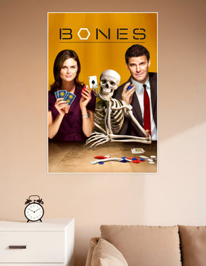Bones TV show promotional poster featuring two cast members and a skeleton playing poker on a golden background with bold BONES title text