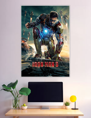 Iron Man 3 movie poster showing Tony Stark in damaged red and gold Mark XLII armor kneeling on a surface with arc reactor glowing and multiple Iron Man suits flying in the background