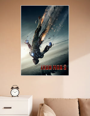 Iron Man 3 movie poster showing Tony Stark falling in a damaged burning Iron Man suit with debris and fire against a dark sky