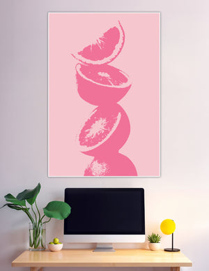 Minimalist pink grapefruit slices stacked on pink background
