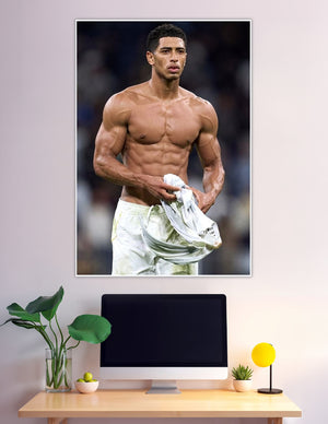 Shirtless muscular footballer holding jersey after match