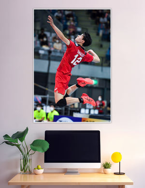 Volleyball player number 12 jumping mid-air spike