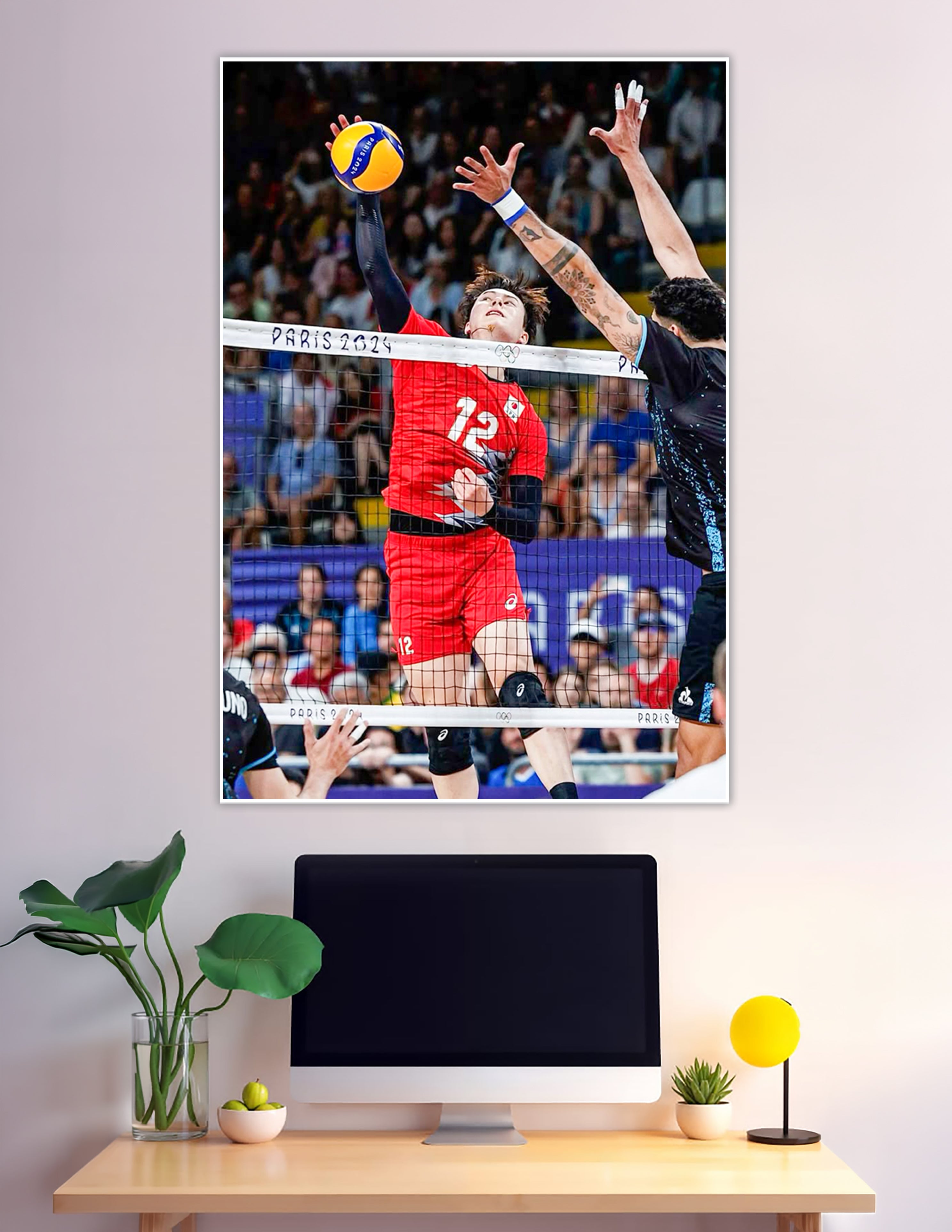 Player number 12 spiking volleyball at Paris 2024 Olympics