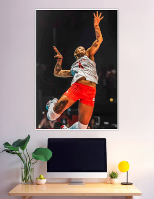 Tattooed female volleyball player jumping mid-air spike