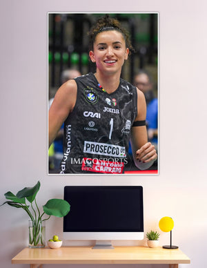 Smiling female volleyball player in black Joma jersey number one